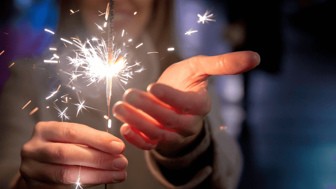 A photo of person holding a sparkle celebrating New Year