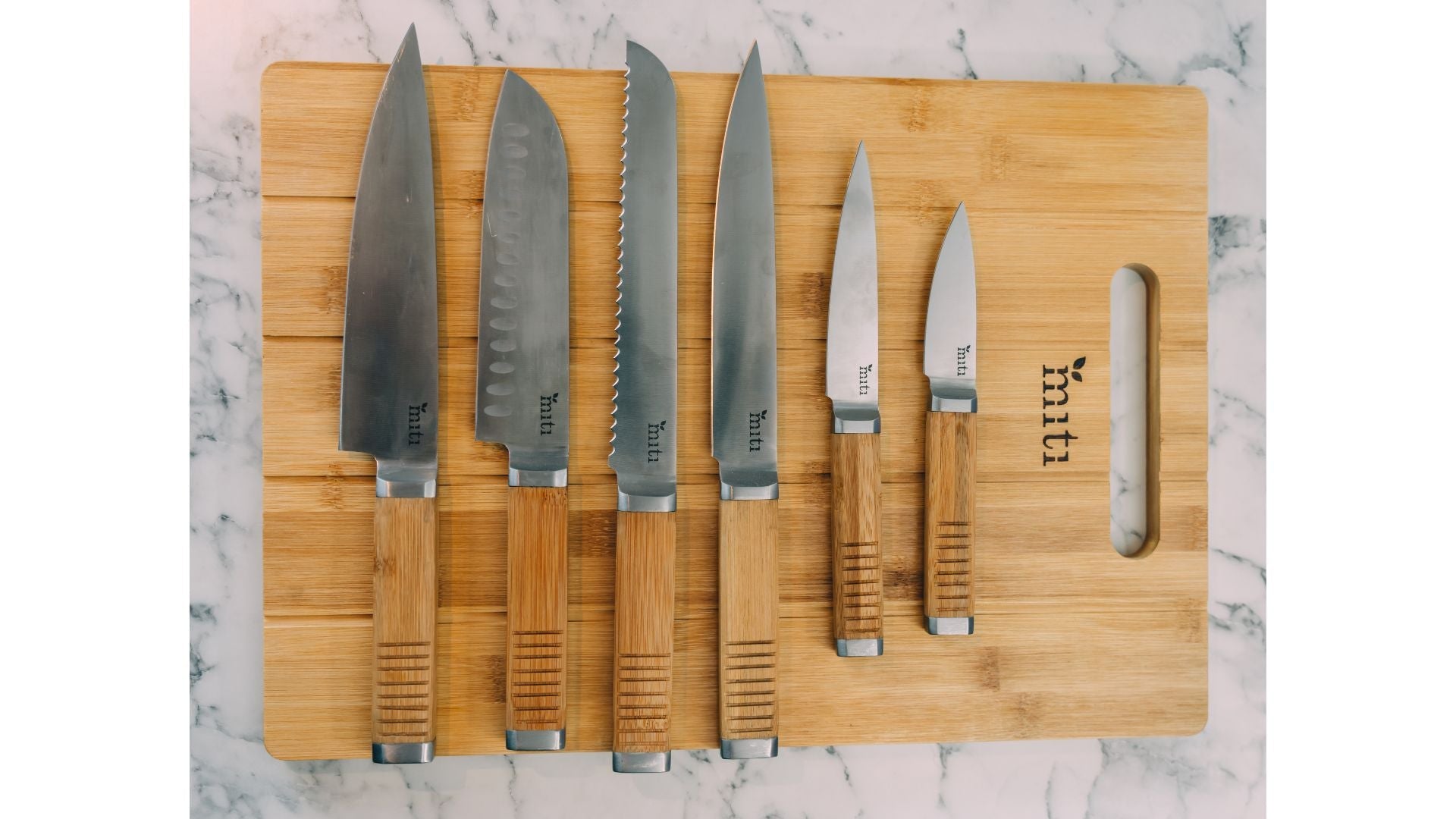MITI bamboo chopping boards and six-piece kitchen knife set arranged in a modern kitchen